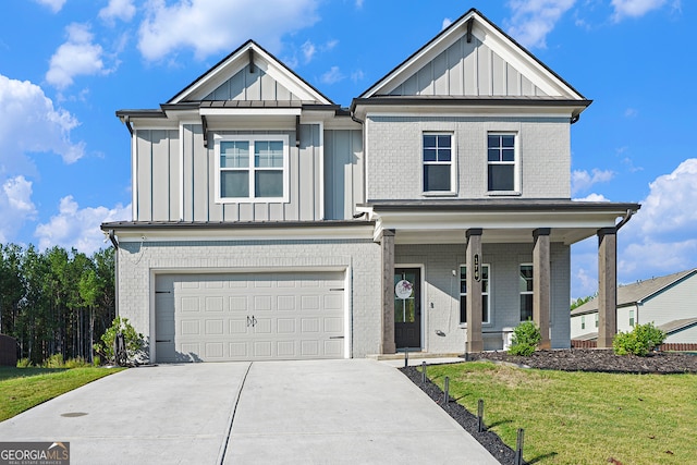 view of front of property with a garage and a front lawn