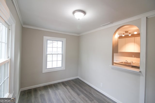 unfurnished room featuring wood-type flooring and crown molding