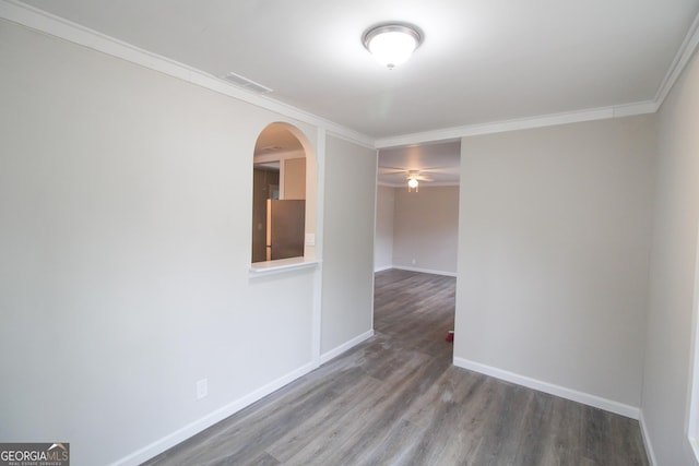 unfurnished room with dark hardwood / wood-style flooring and crown molding