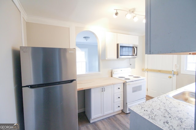 kitchen with crown molding, white cabinetry, sink, and appliances with stainless steel finishes