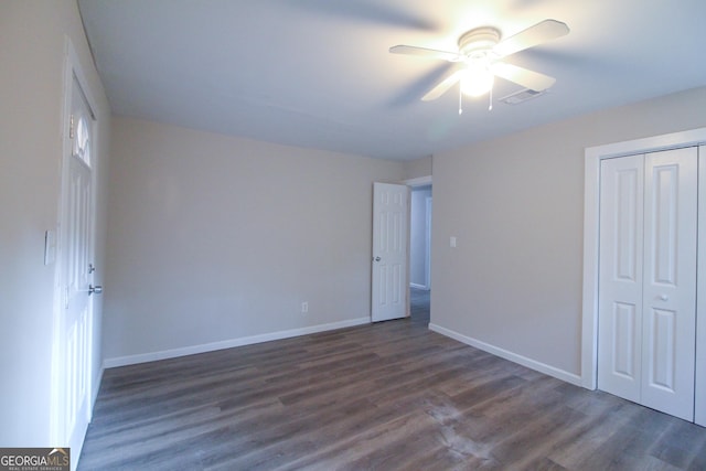 spare room featuring ceiling fan and dark wood-type flooring