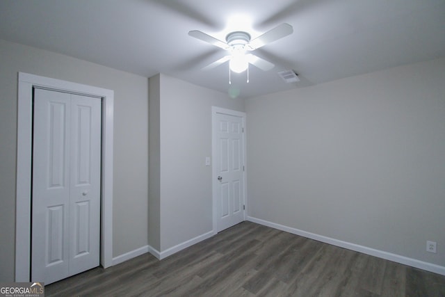 interior space with dark hardwood / wood-style flooring and ceiling fan