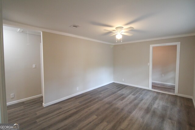 empty room featuring crown molding, ceiling fan, and dark wood-type flooring