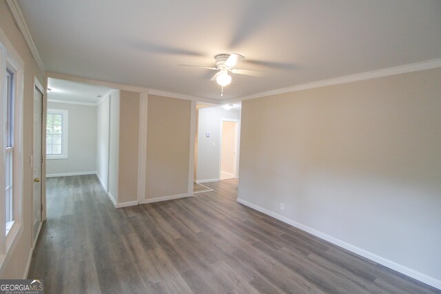 unfurnished room featuring ceiling fan, dark hardwood / wood-style flooring, and crown molding