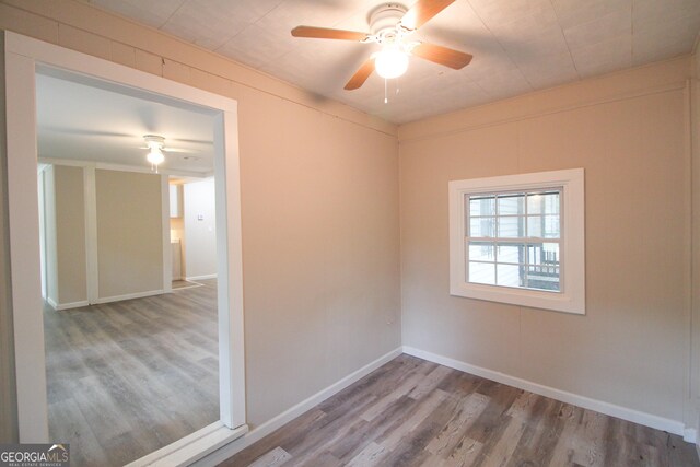 spare room featuring hardwood / wood-style floors and ceiling fan