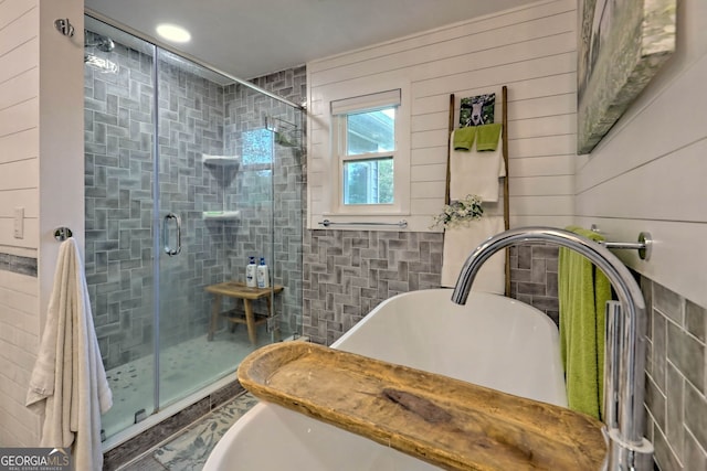 bathroom featuring shower with separate bathtub