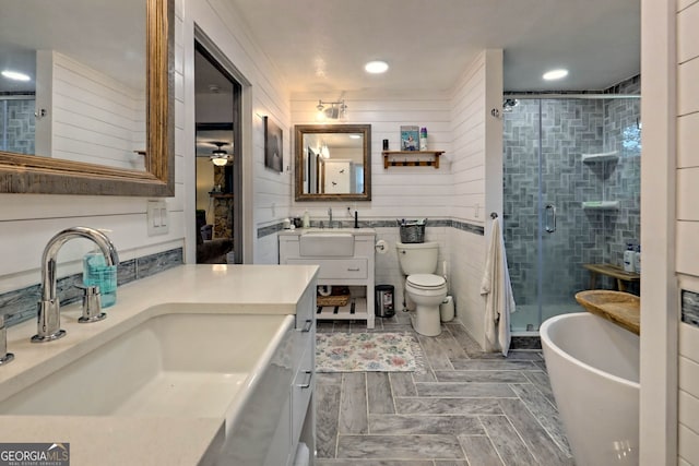 full bathroom with crown molding, shower with separate bathtub, vanity, and toilet