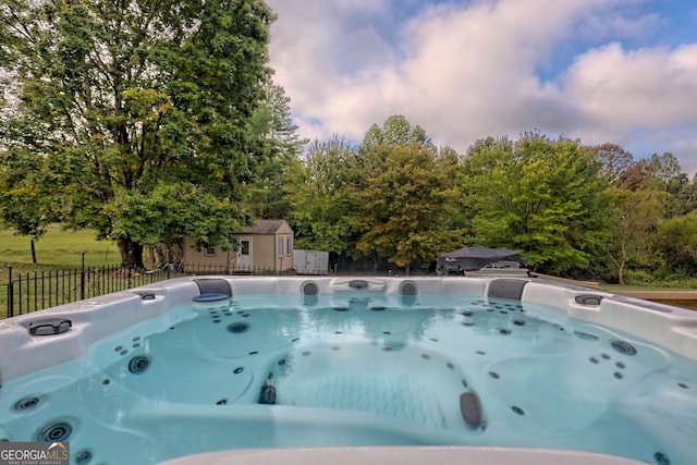 view of swimming pool with a hot tub