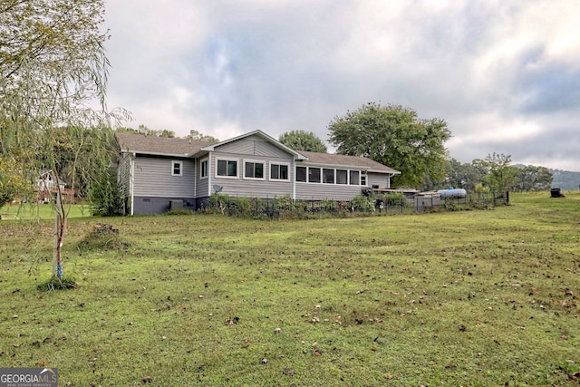 rear view of property with a yard