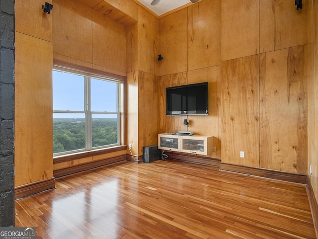 unfurnished living room featuring ceiling fan and hardwood / wood-style floors