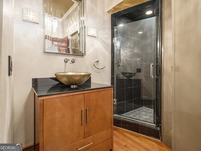 bathroom with vanity, hardwood / wood-style flooring, and walk in shower