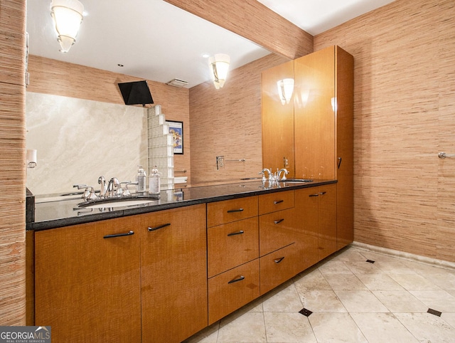 bathroom with beam ceiling, tile patterned floors, and vanity