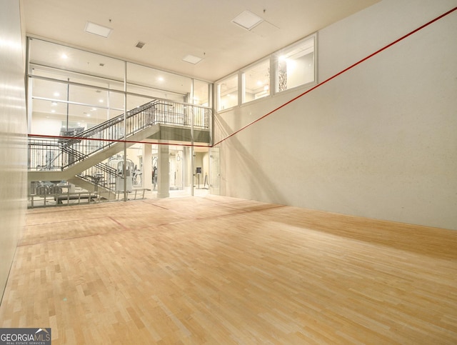 unfurnished living room with a high ceiling and hardwood / wood-style flooring