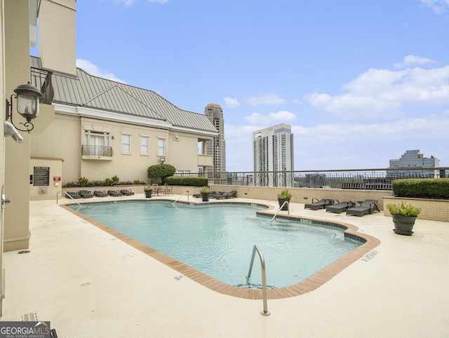 view of swimming pool with a patio