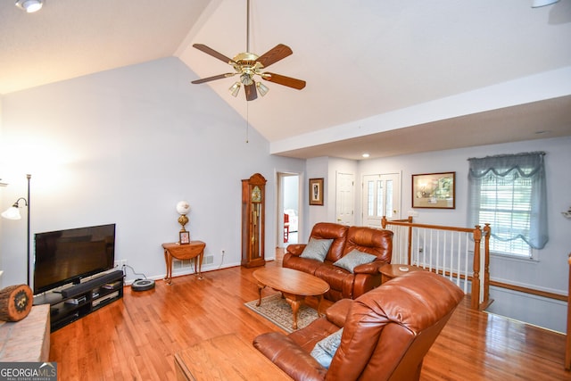 living room with ceiling fan, light wood-type flooring, and high vaulted ceiling