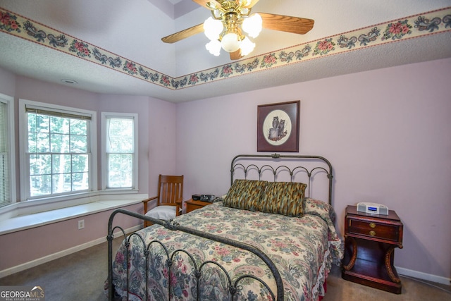 bedroom featuring ceiling fan, carpet floors, and a textured ceiling