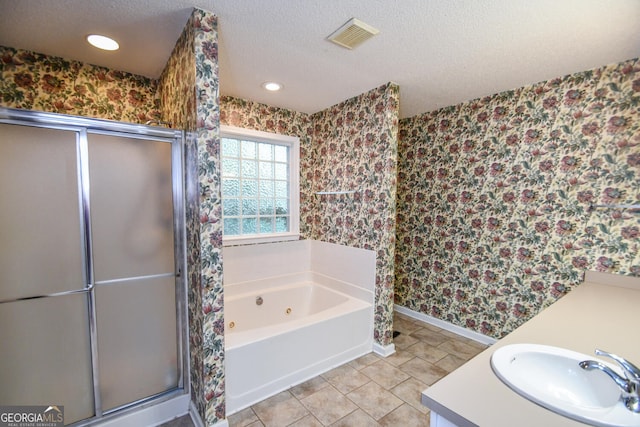 bathroom featuring vanity, separate shower and tub, a textured ceiling, and tile patterned floors