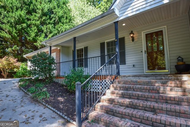 view of exterior entry with a porch