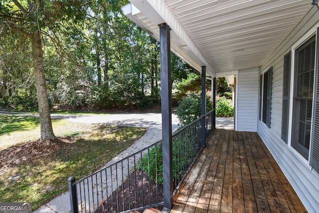 wooden deck featuring a yard