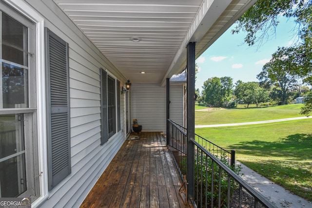 wooden deck with a lawn