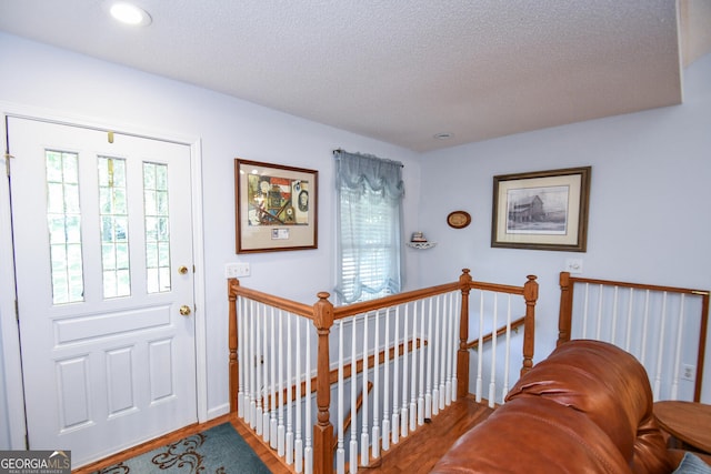 foyer with wood-type flooring and a textured ceiling