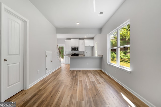 interior space featuring sink and light wood-type flooring