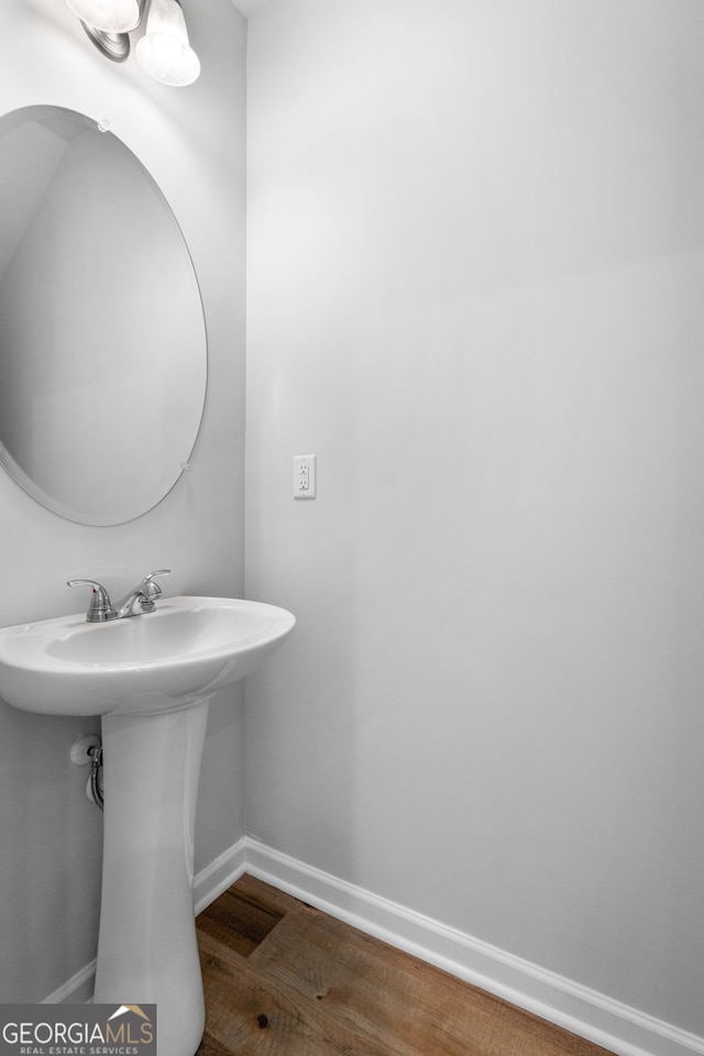 bathroom with hardwood / wood-style flooring and sink