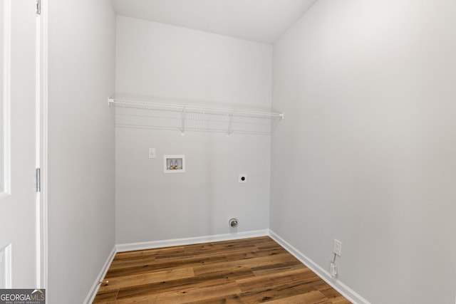 clothes washing area with electric dryer hookup, washer hookup, and dark wood-type flooring