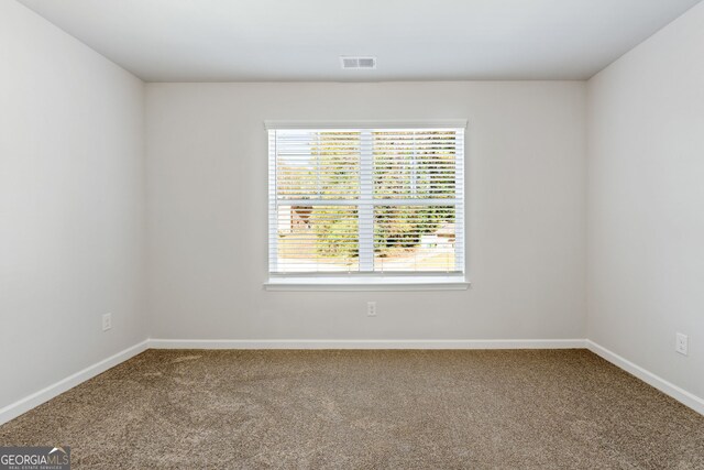 unfurnished bedroom featuring connected bathroom, light carpet, ceiling fan, and a closet