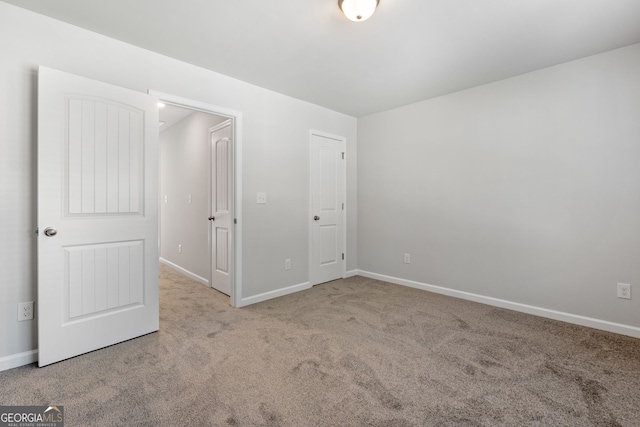 unfurnished bedroom featuring light colored carpet