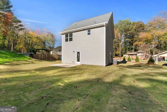 back of property featuring a patio and a yard