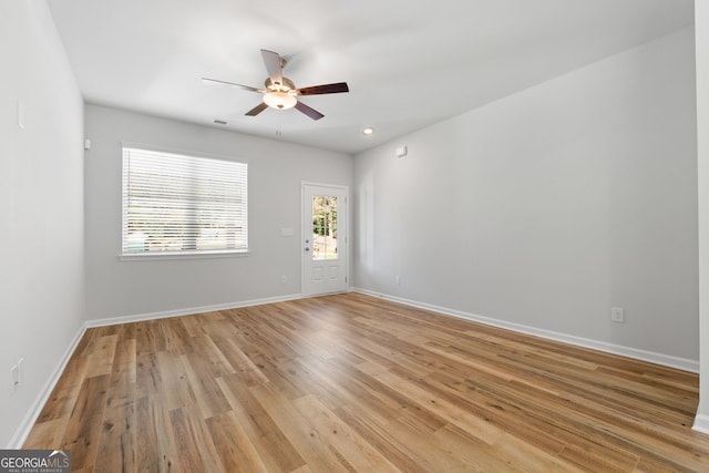 spare room with ceiling fan and light hardwood / wood-style floors