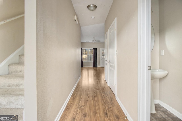 corridor with wood-type flooring