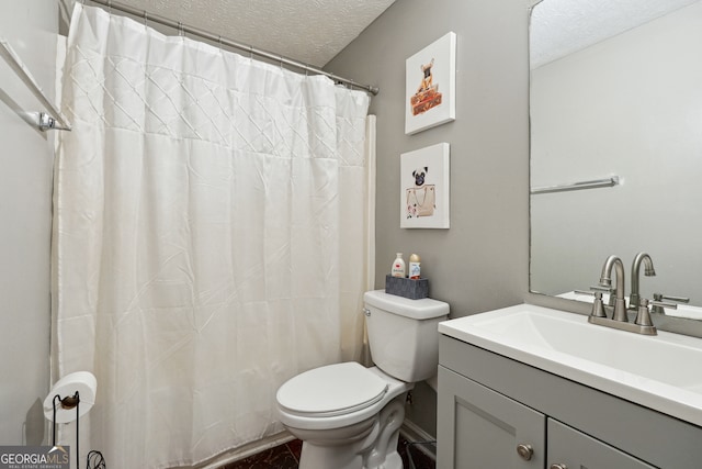 full bathroom featuring shower / bath combo with shower curtain, a textured ceiling, vanity, and toilet