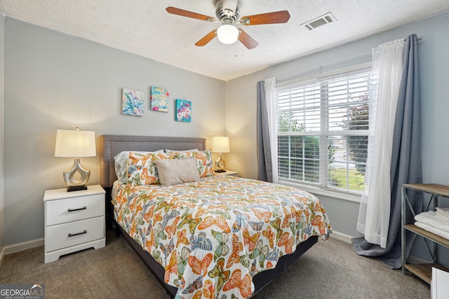 carpeted bedroom with a textured ceiling and ceiling fan