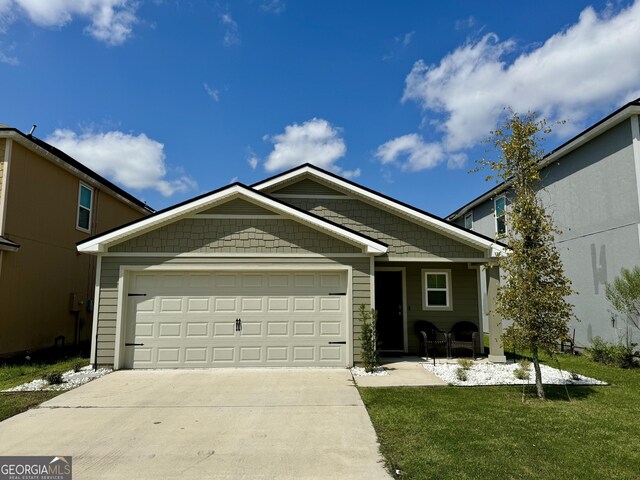 view of front of house with a garage and a front lawn