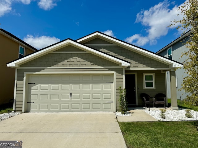 view of front of house featuring a garage and a front lawn