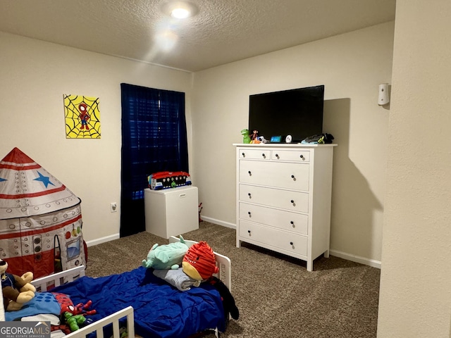 bedroom featuring dark carpet and a textured ceiling