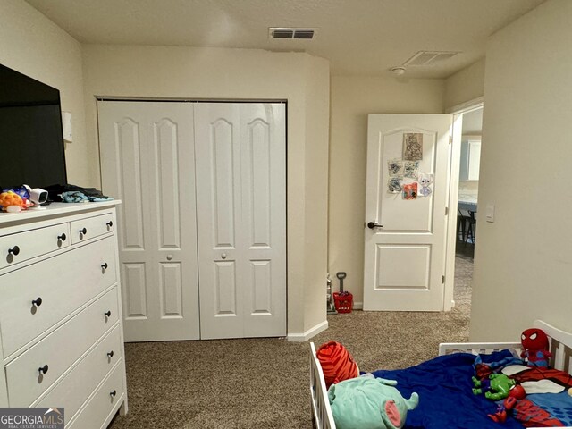 carpeted bedroom with a closet