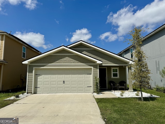 view of front of house featuring a garage and a front lawn