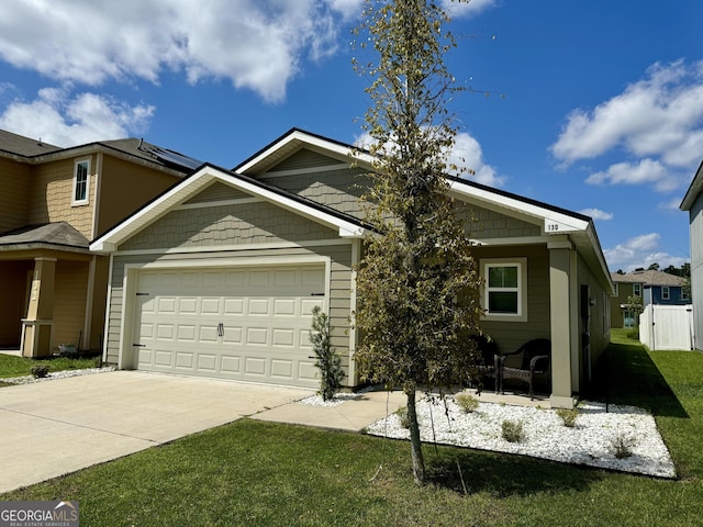 view of front of house with a garage and a front yard