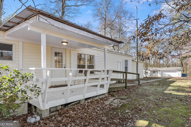 view of side of home featuring a porch and a deck