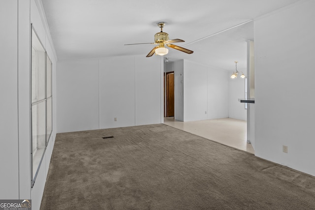 unfurnished living room featuring carpet floors and ceiling fan with notable chandelier