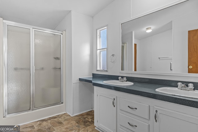 bathroom featuring vanity and an enclosed shower