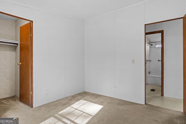 unfurnished bedroom featuring light carpet