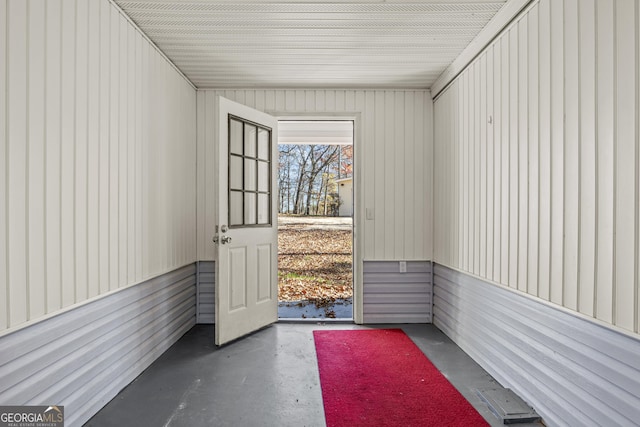 entryway with wooden walls