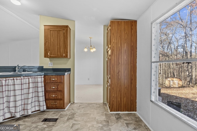 kitchen featuring a chandelier, decorative light fixtures, and sink