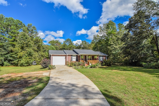 ranch-style home featuring a garage and a front lawn