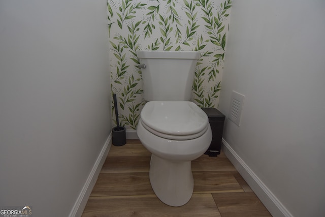 bathroom featuring wood-type flooring and toilet