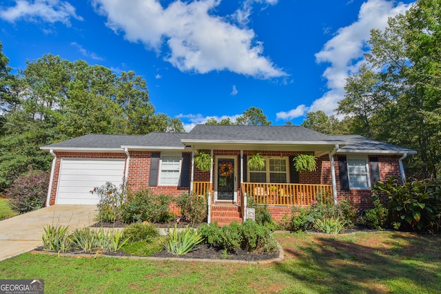 ranch-style house featuring a garage, covered porch, and a front yard